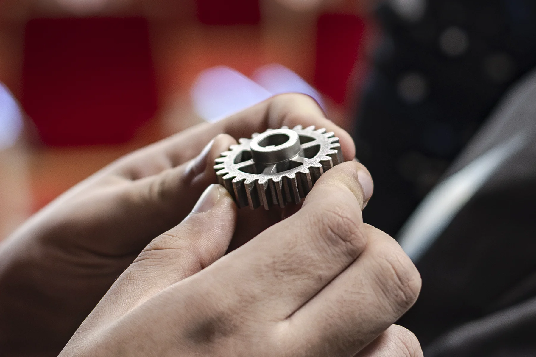 metalowe koło zębate z druku 3D trzymane w rękach